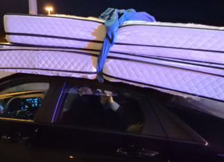 Driver fined for driving with mattresses tied to roof with bedsheets Image source: OPP Central Region - Twitter.