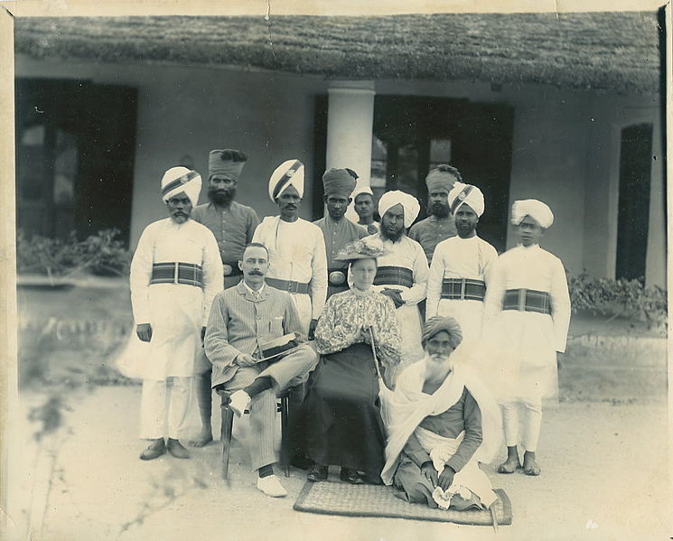 745px A British couple with Indian policemen and peons in the 1900s 2