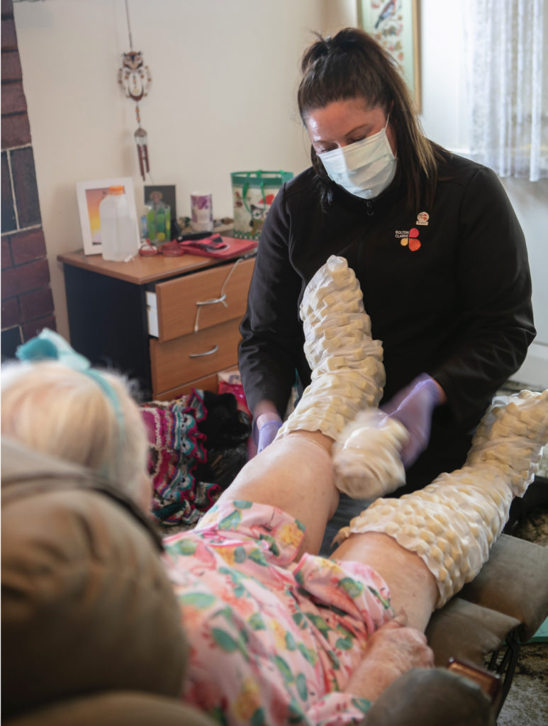 Nurse attending to a client - Image credit Bolton Clarke Research Institute
