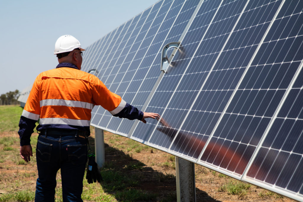 Rugby Run staff member checks solar panel; Image Source: Supplied