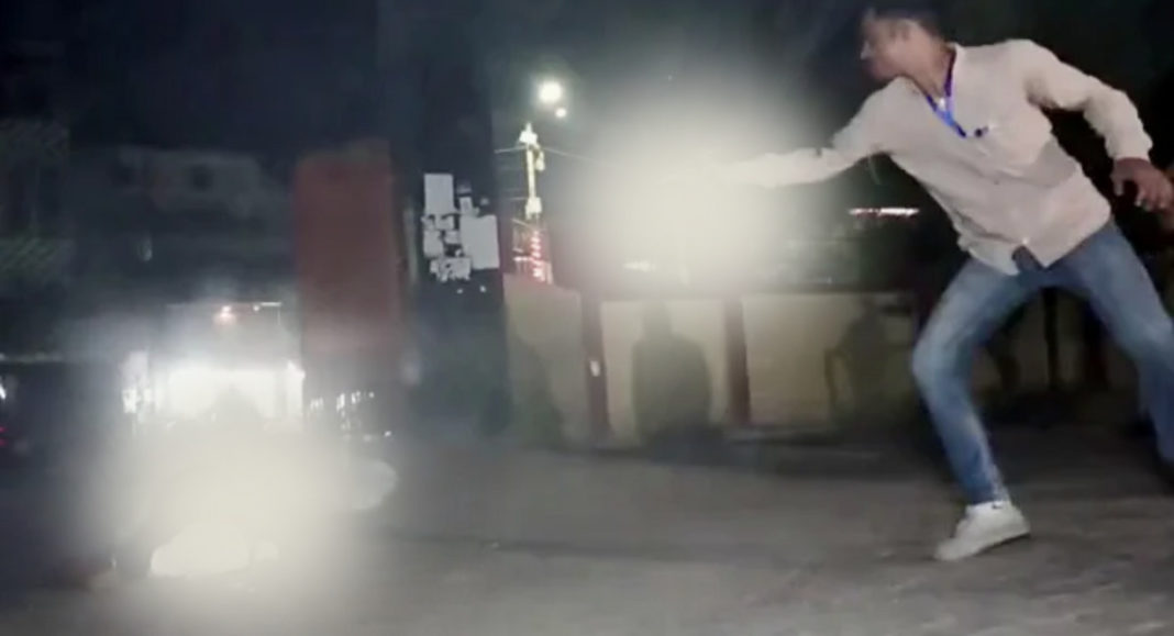 An assilant is seen shooting at Gangster Atiq Ahmed while on the way for a medical examination, in Prayagraj, Atiq's brother Khalid Azim alias Ashraf also shot dead in the firing. (ANI Photo)