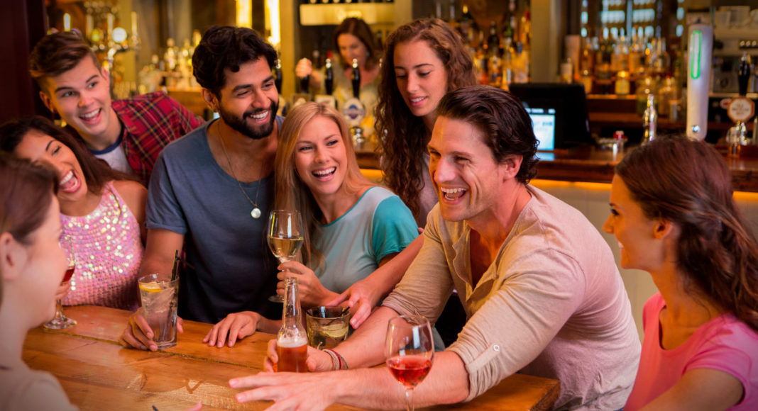 A Group of people at bar; Image Source @Canva