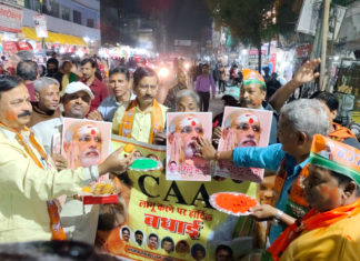 Activists celebrate after Central Government announced the notification of the rules to implement the Citizenship Amendment Act, at Kodai Chowki, in Varanasi; Image Source: (ANI Photo)