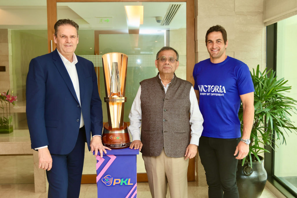 L R Visit Victoria CEO Brendan McClements Mashal Sports CEO and PKL League Commissioner Anupam Goswami and Josh Kennedy with the PKL Trophy 75
