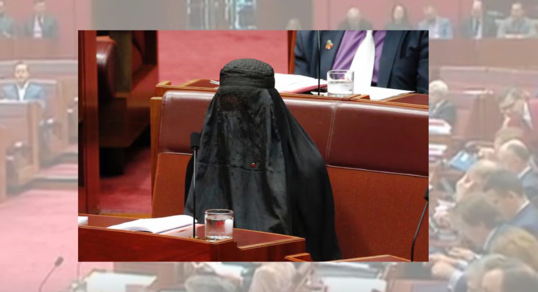 Image: One Nation leader Senator Pauline Hanson wearing a Burqa in Australian parliament, 2017 (Source: ABC News screenshot)