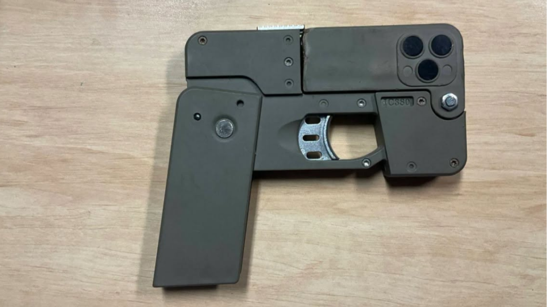 Image: Police allege they found two handguns designed to fold and resemble mobile phones (Source: Queensland Police - Facebook)